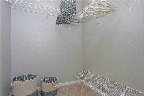 Walk-in closet with ample hanging and shelving storage space