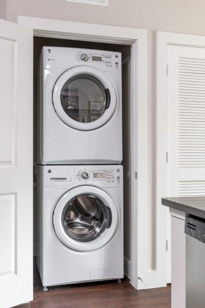 Laundry closet with stacked, full size washer and dryer