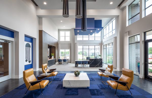 Clubhouse interior with modern decorations, lounging options, and resident service desks