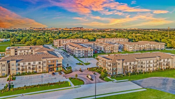 Aerial view of the Lake Walk at Traditions community surrounded by lush greenery and landscaping
