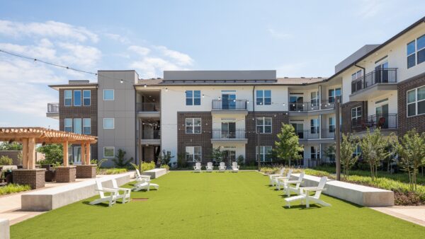 Large, open turf area in front of the apartment homes with Adirondack chairs