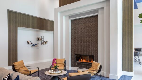 Clubhouse interior with lounge chairs, and electric fire place